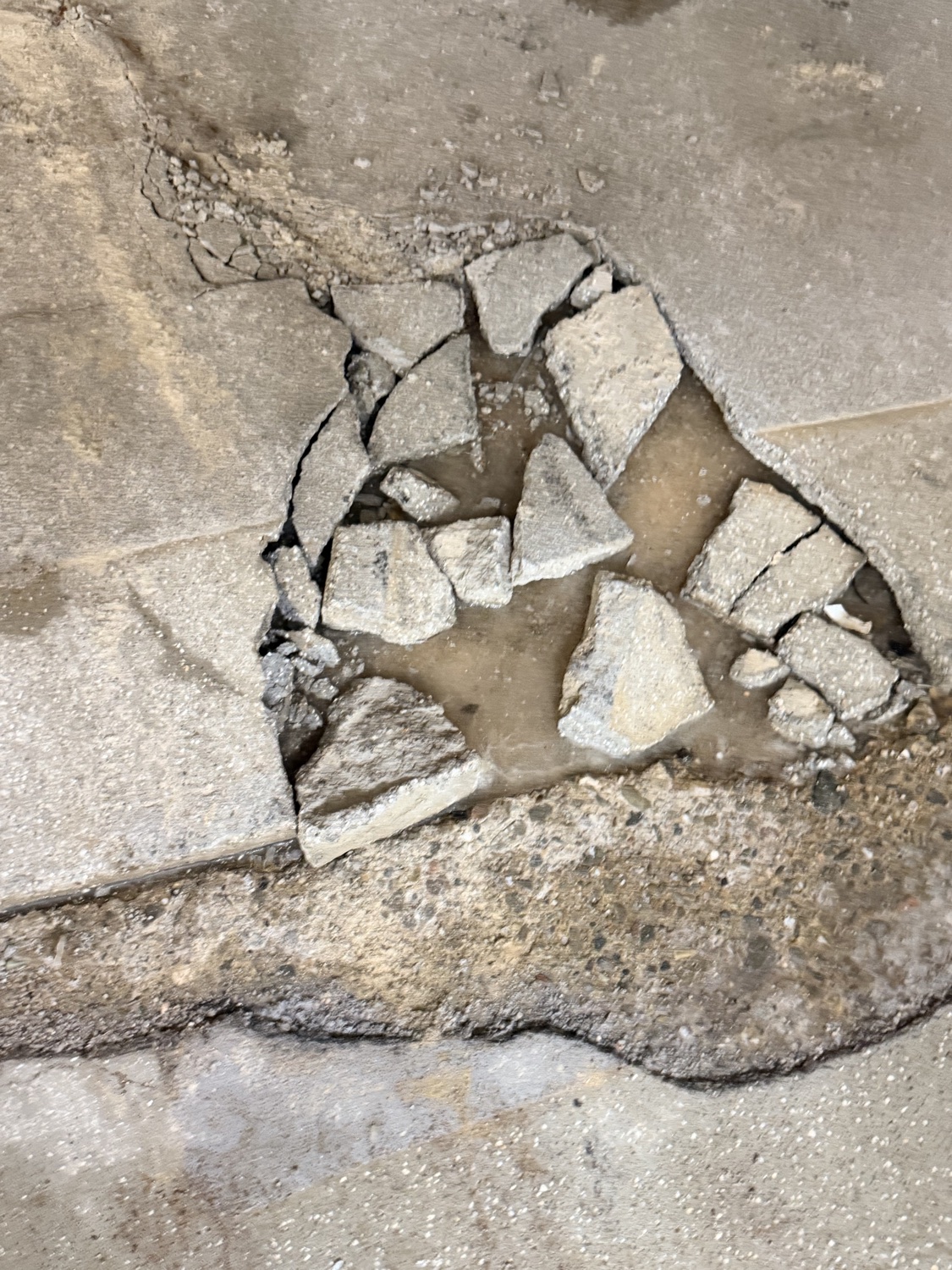 Concrete surface broken up and deteriorated by moisture damage