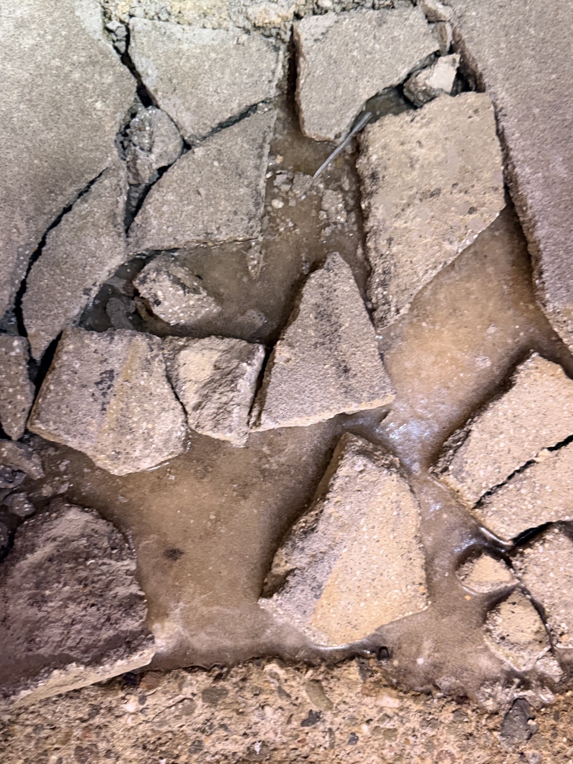 Section of concrete slab shattered and broken apart