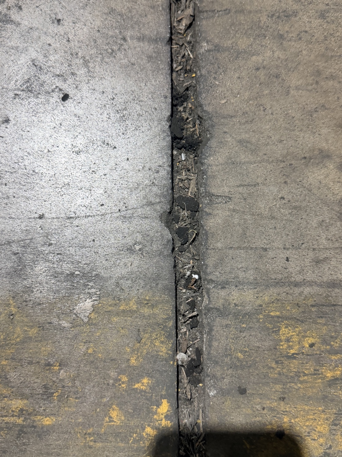 Control joint packed with debris and dirt after its filler failed